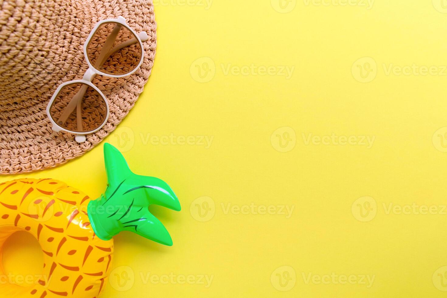 sunglasses , striped retro hat and swimming circle on yellow background. summer vacation concept. photo