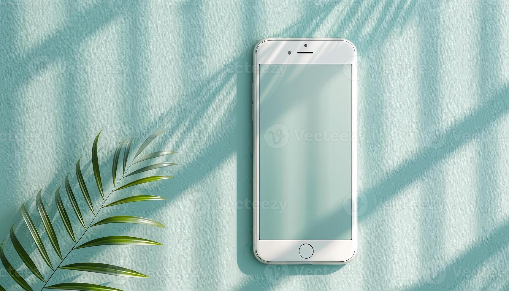 Minimalist Smartphone with Tropical Leaf on Light Blue Background photo