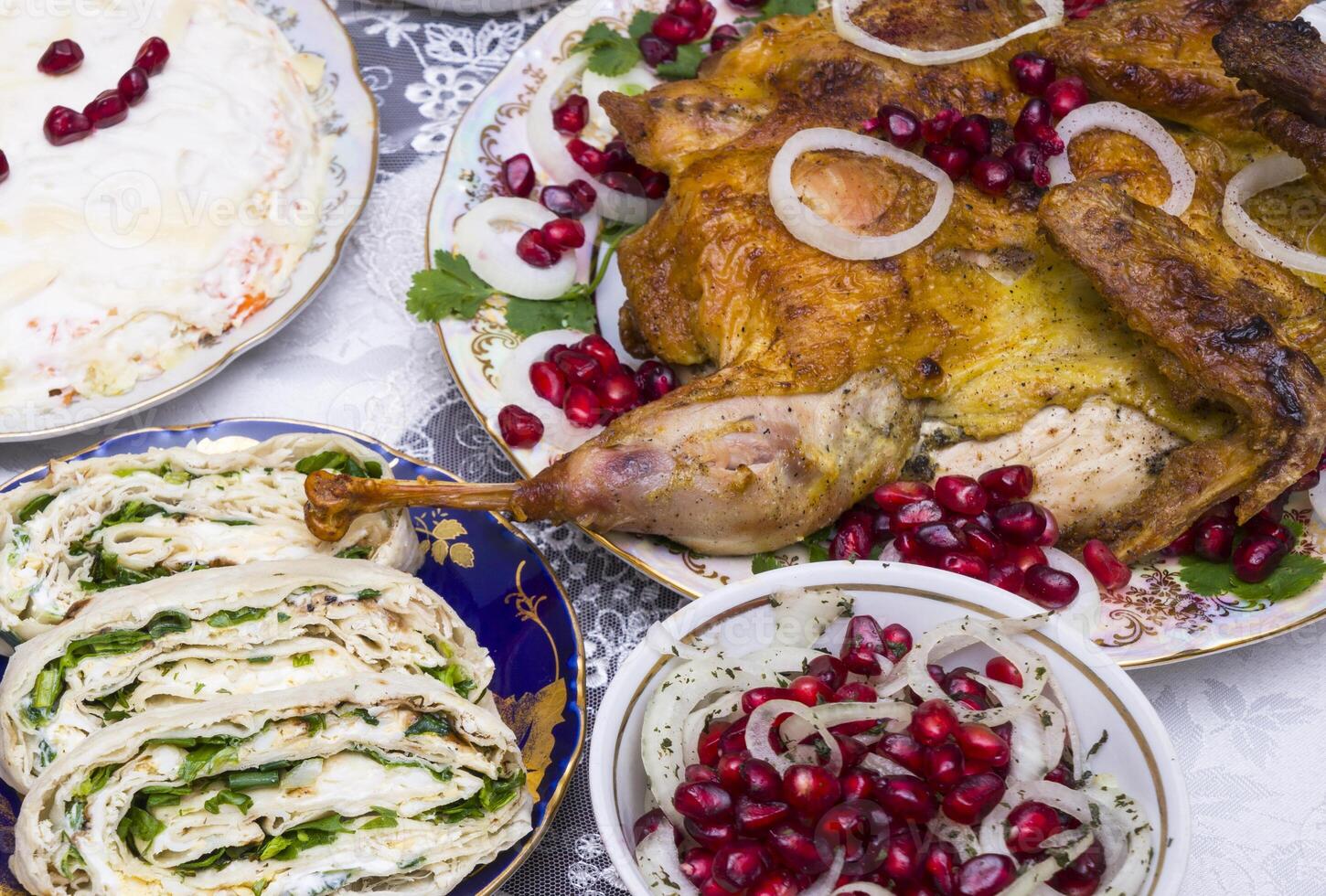 Different food on a wooden table, grilled chicken legs, buffalo wings, salad, photo