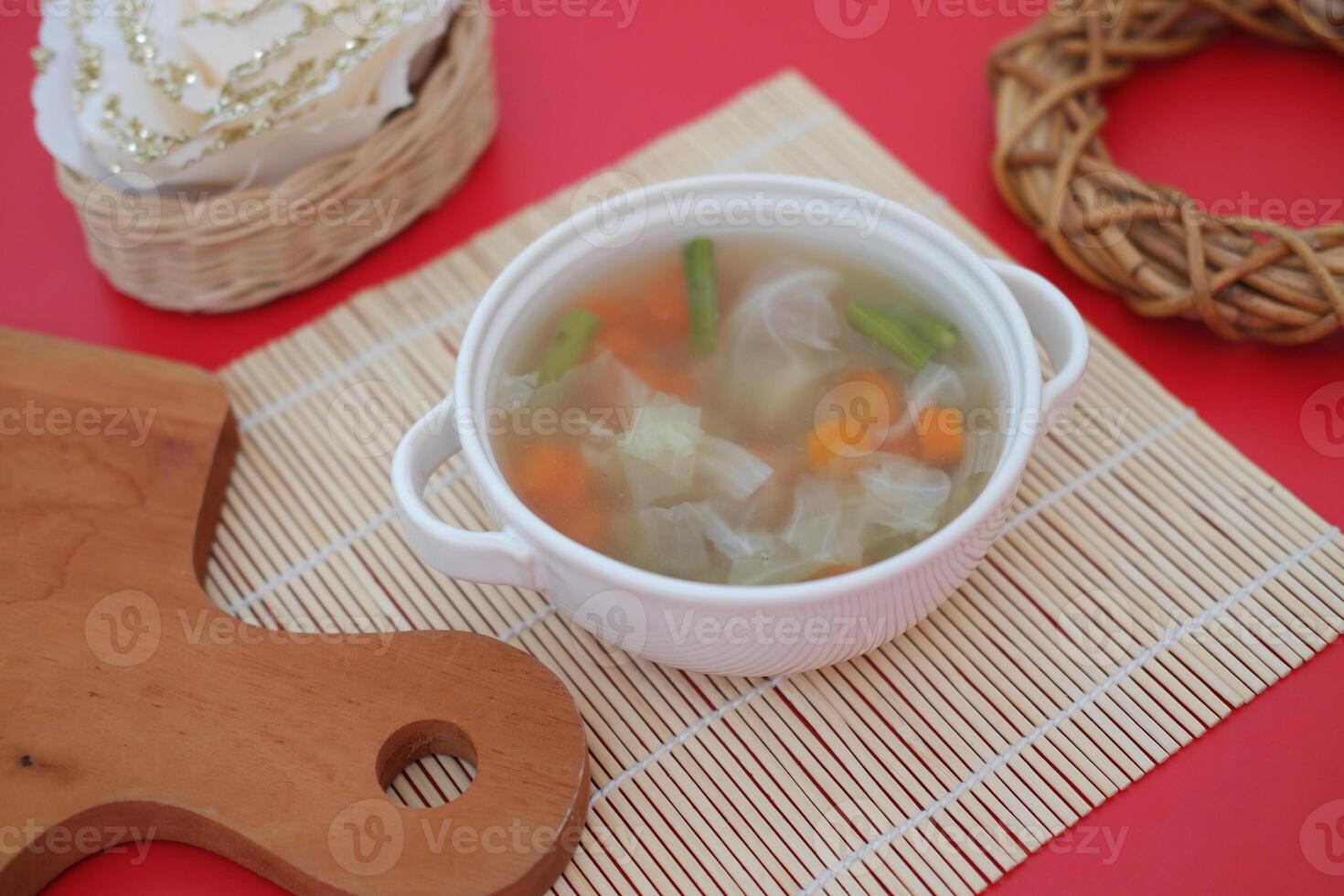 A bowl of vegetable soup on a table photo