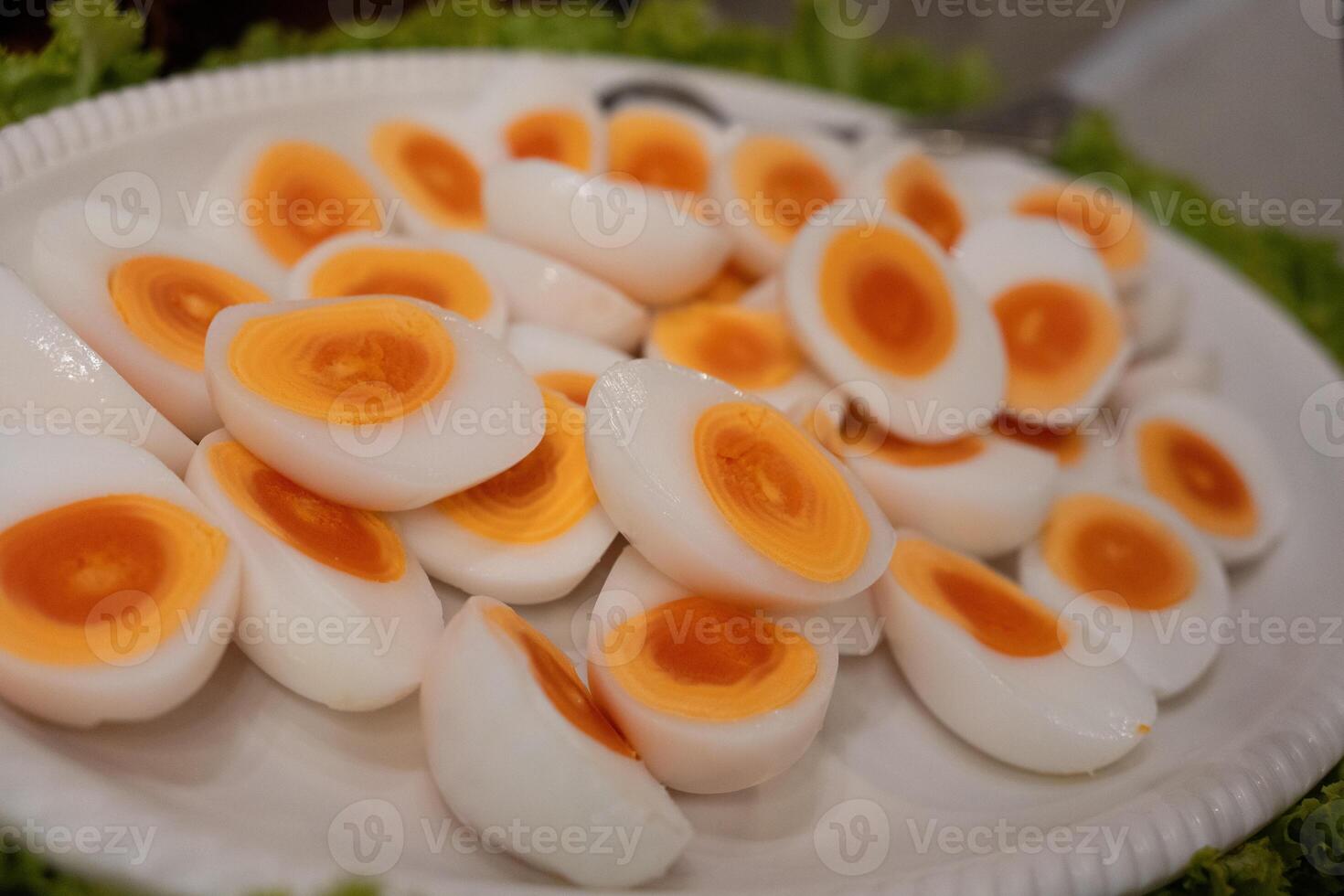 Halves of a boiled egg, a hard boiled egg cut in half on big dish photo