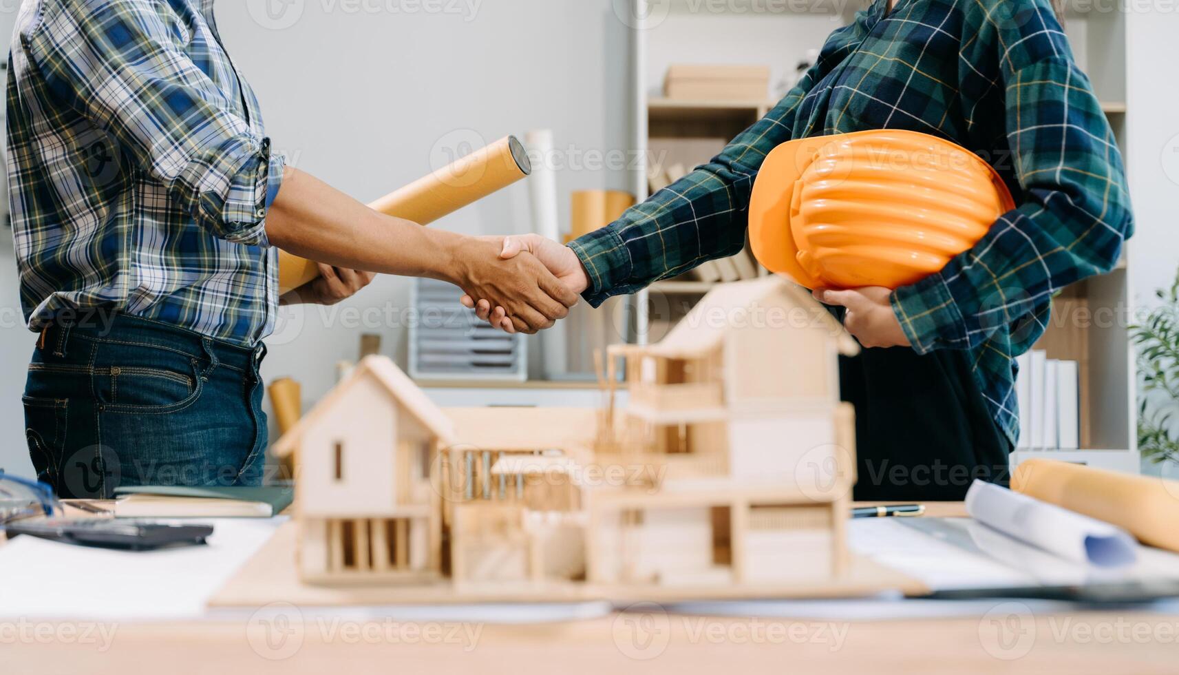 Engineer desk with object paper and tablet with blurry engineer teamwork hardworking to consults about their building photo