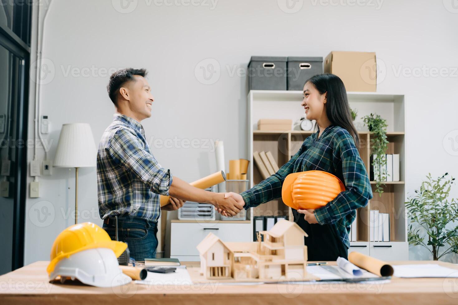 Engineer desk with object paper and tablet with blurry engineer teamwork hardworking to consults about their building photo