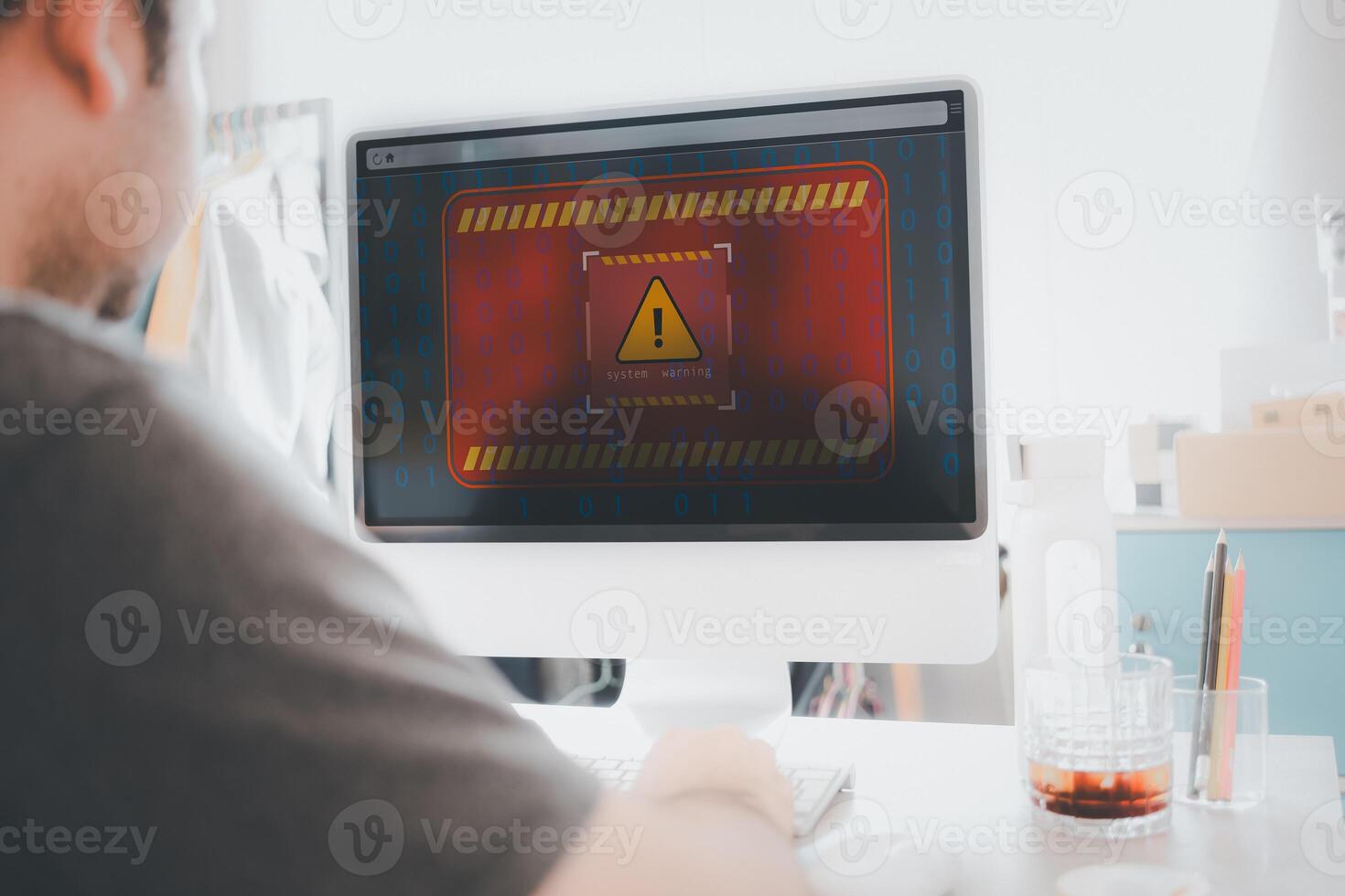 Man use computer at home with warning triangle sign for warning error Hack Alert System Warning cyber attack photo