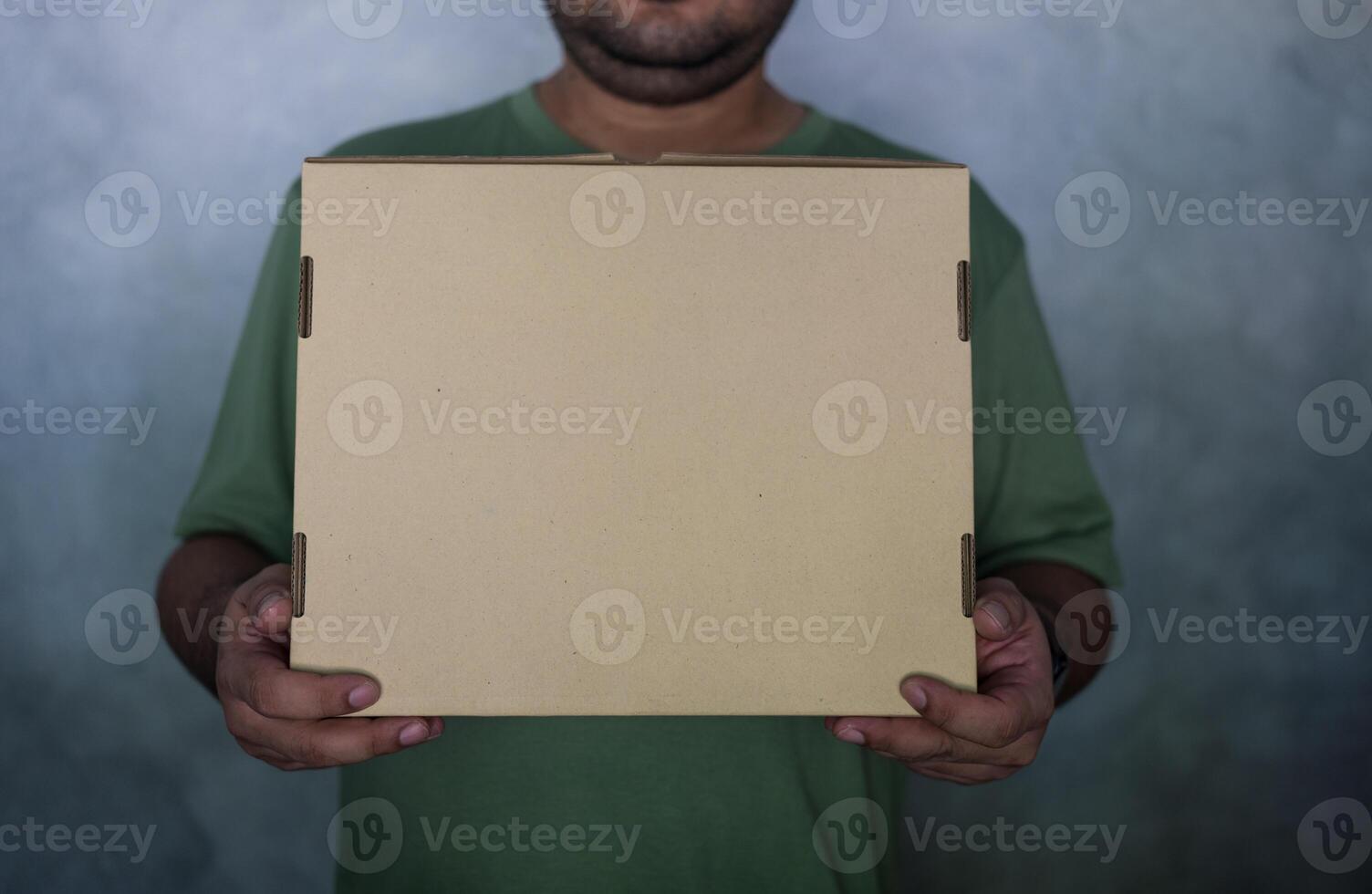 Close up of man with cardboard box parcel photo