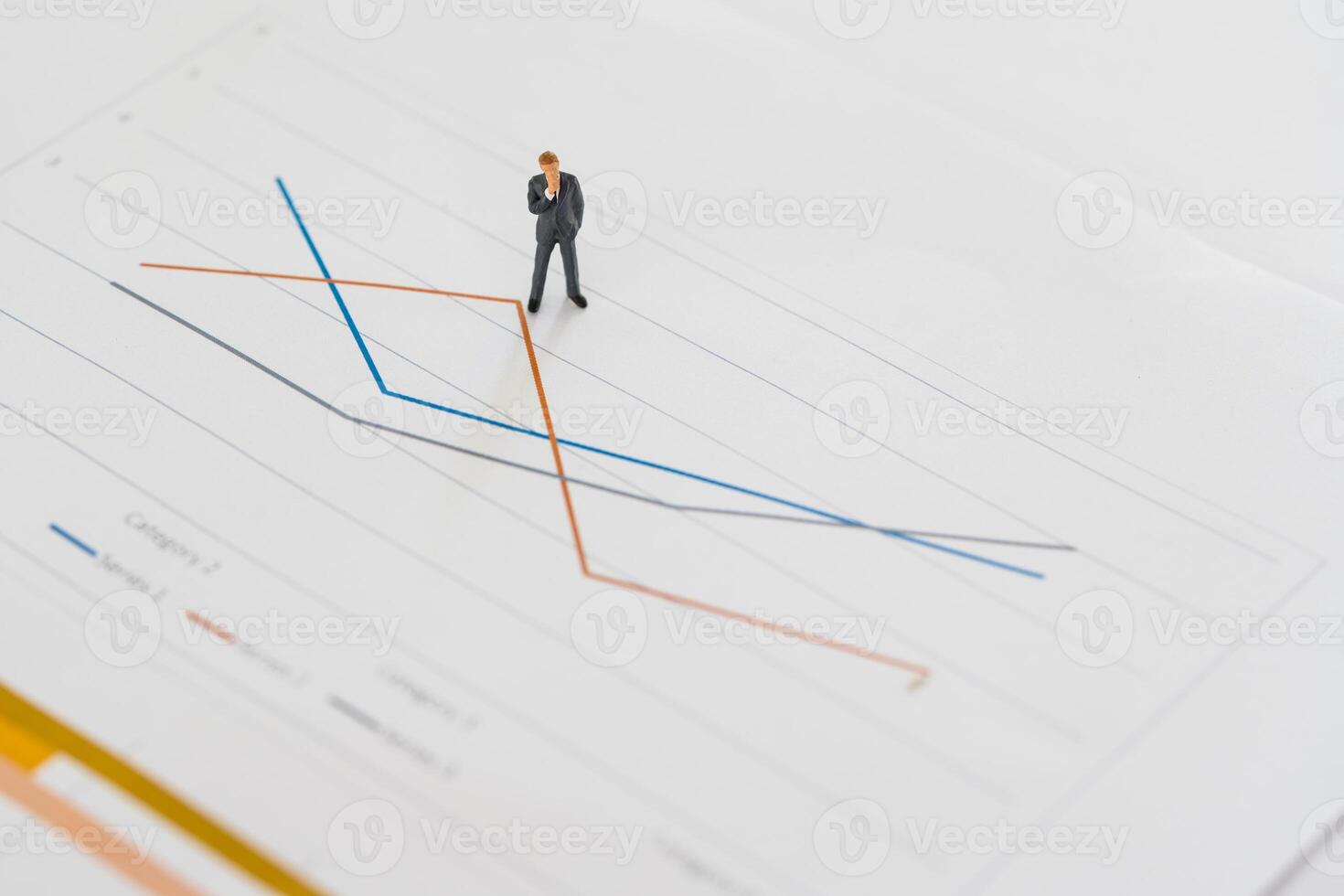 Miniature businessman thinking with the project for presenting investment concept on line graph. photo