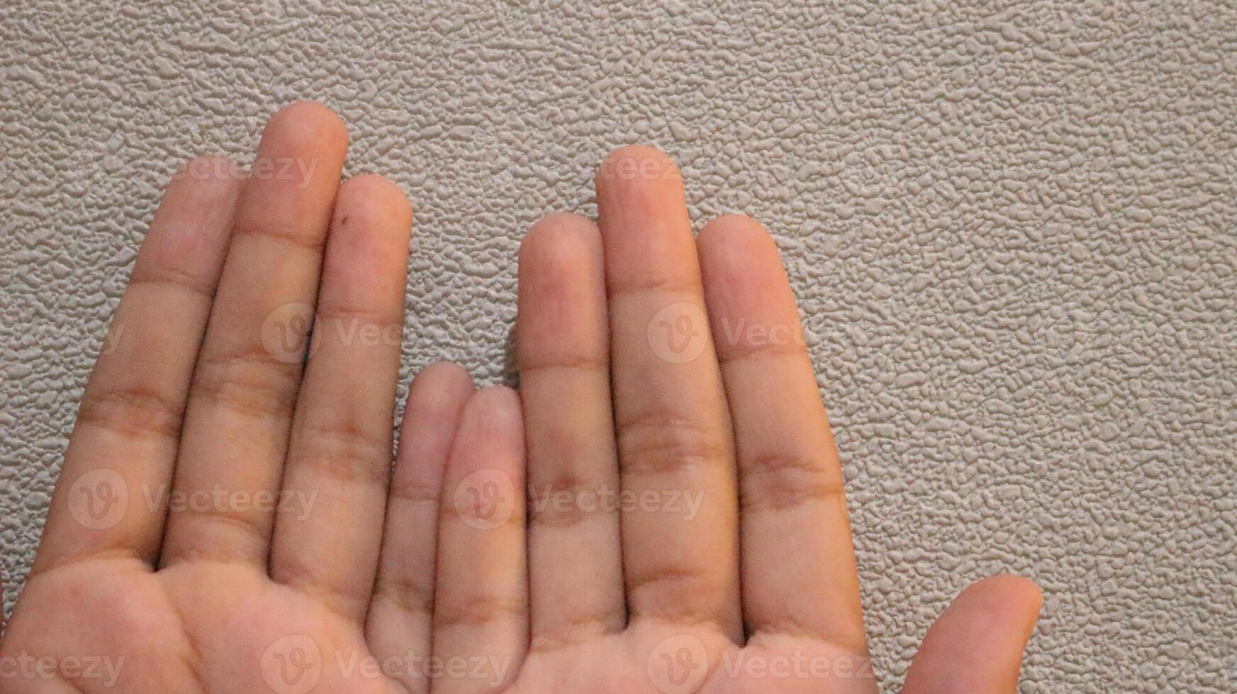Photo of two small children's hands looking up