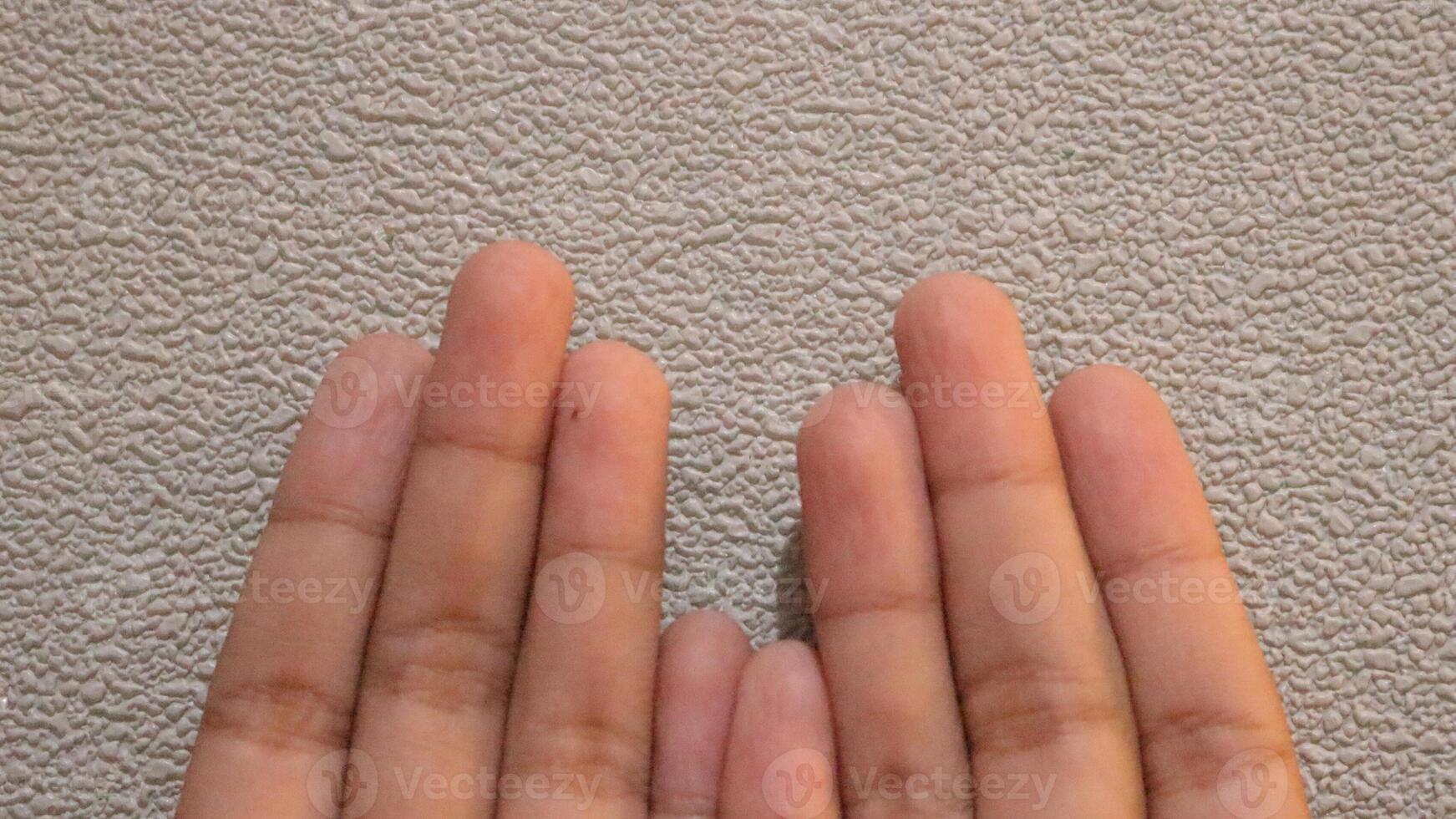 Photo of two small children's hands looking up