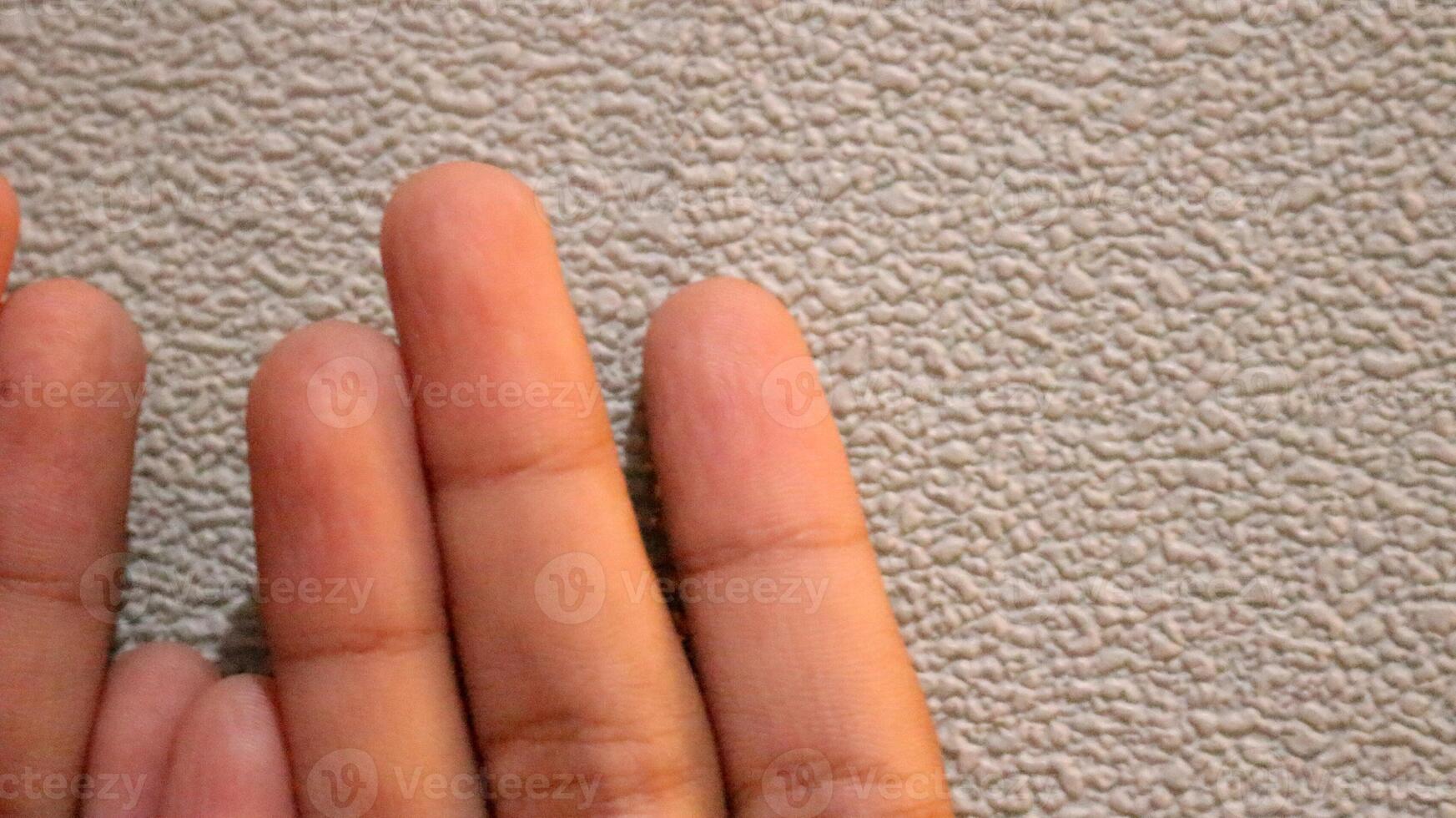 Photo of two small children's hands looking up
