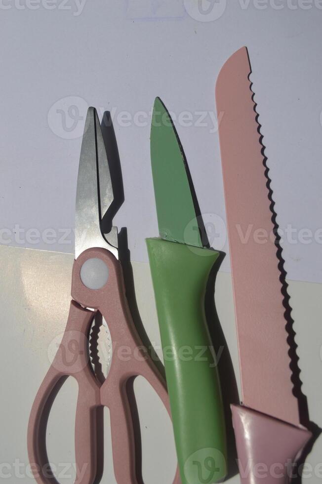 sharp kitchen knives used for cooking, knife set of various shapes and uses put together on a white background photo
