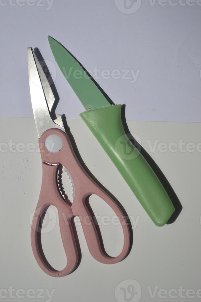 sharp kitchen knives used for cooking, knife set of various shapes and uses put together on a white background photo