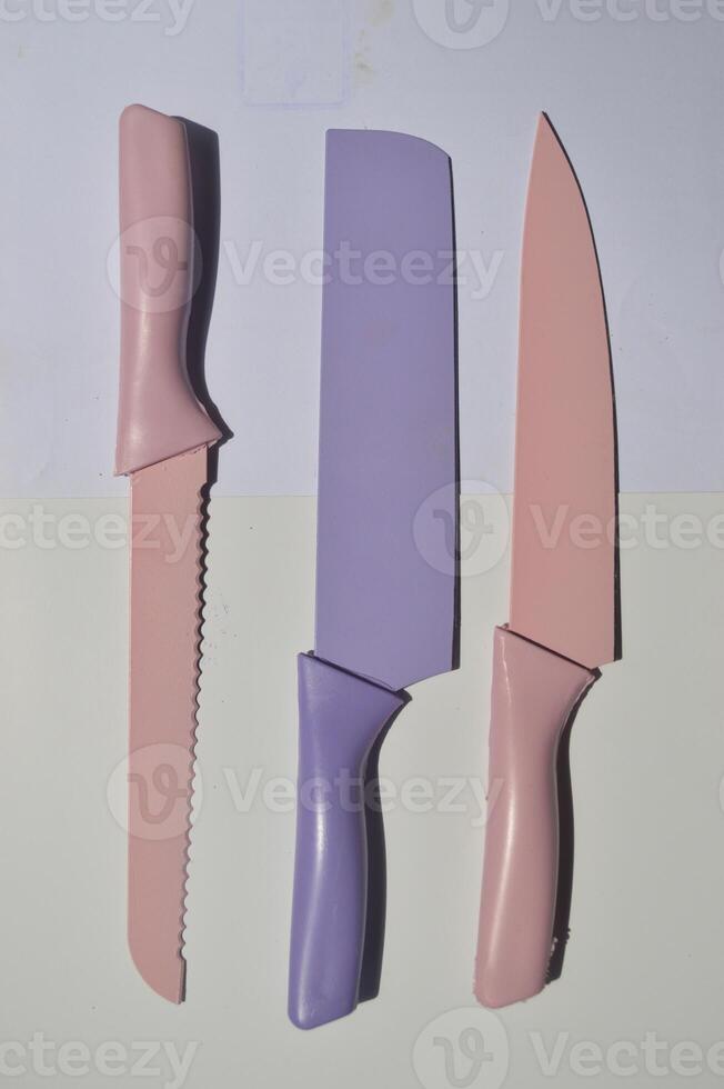 sharp kitchen knives used for cooking, knife set of various shapes and uses put together on a white background photo