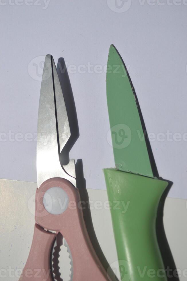 sharp kitchen knives used for cooking, knife set of various shapes and uses put together on a white background photo