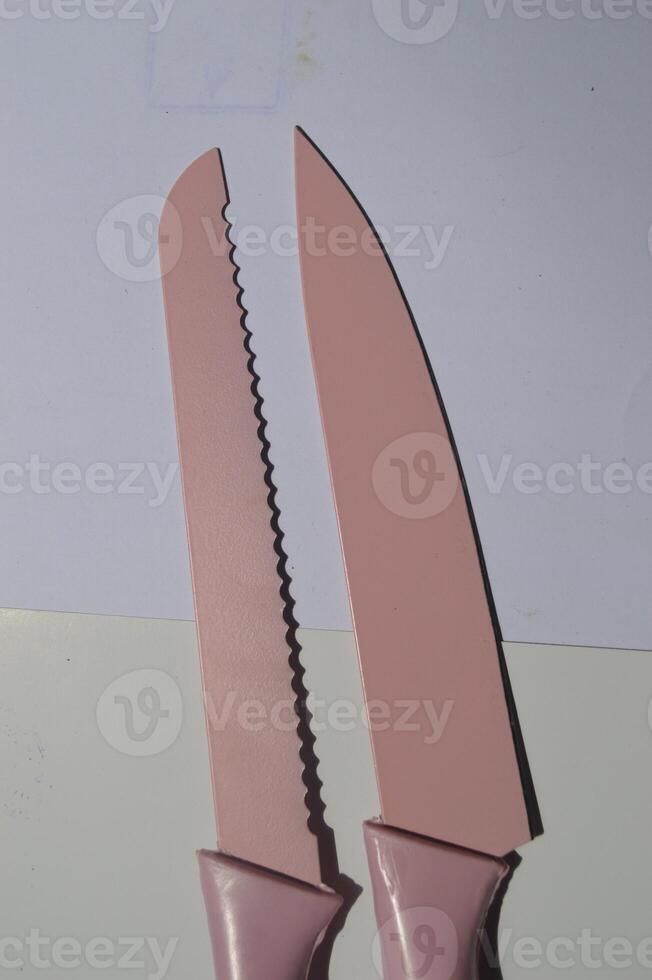 sharp kitchen knives used for cooking, knife set of various shapes and uses put together on a white background photo
