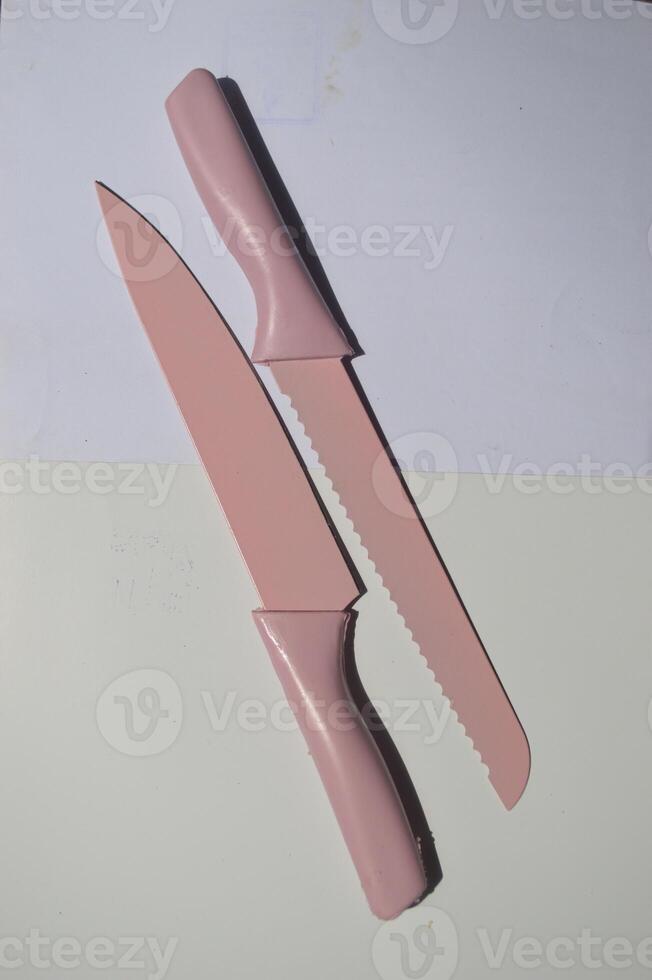 sharp kitchen knives used for cooking, knife set of various shapes and uses put together on a white background photo