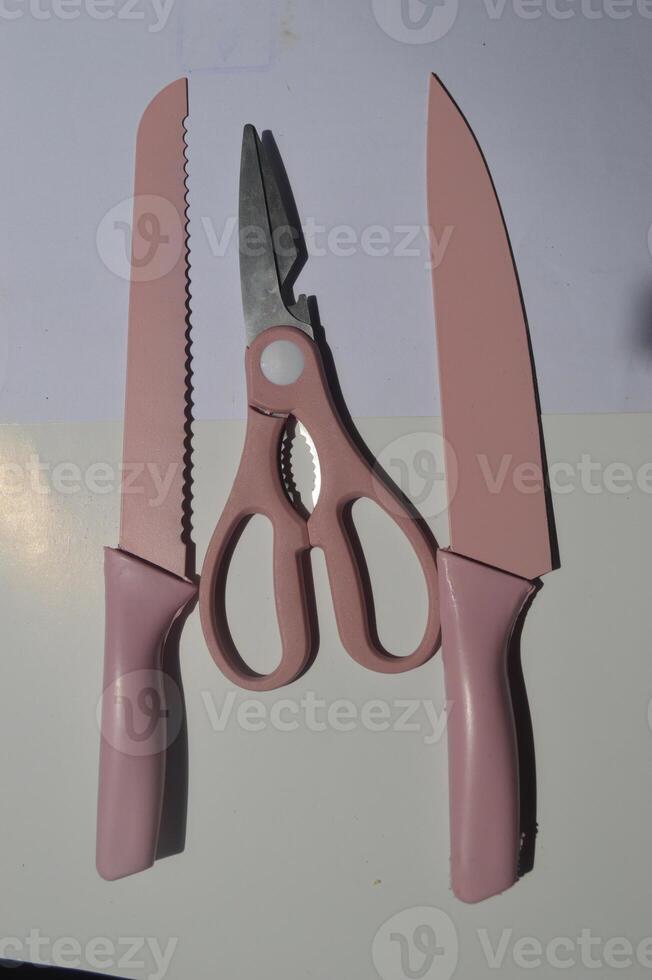 sharp kitchen knives used for cooking, knife set of various shapes and uses put together on a white background photo