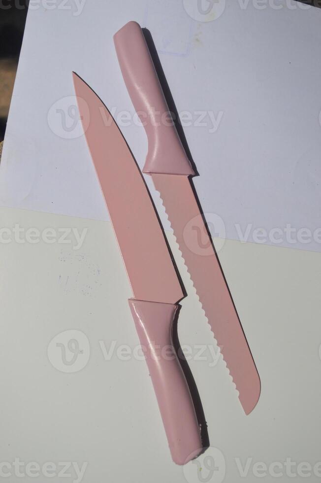 sharp kitchen knives used for cooking, knife set of various shapes and uses put together on a white background photo