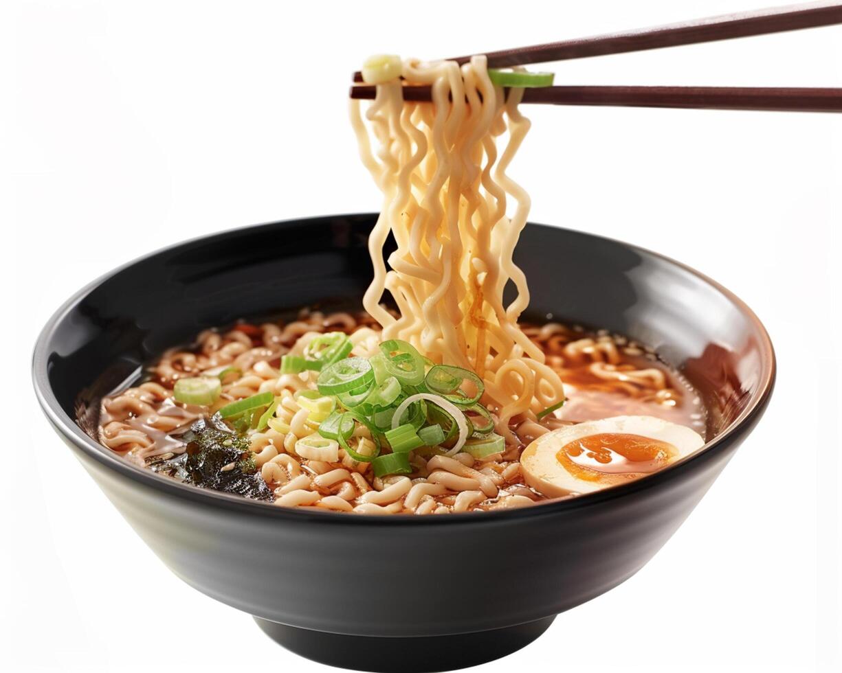 a bowl of ramen with chopsticks and an egg photo