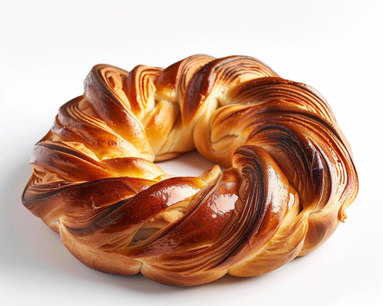 a large round braided bread on a white background photo