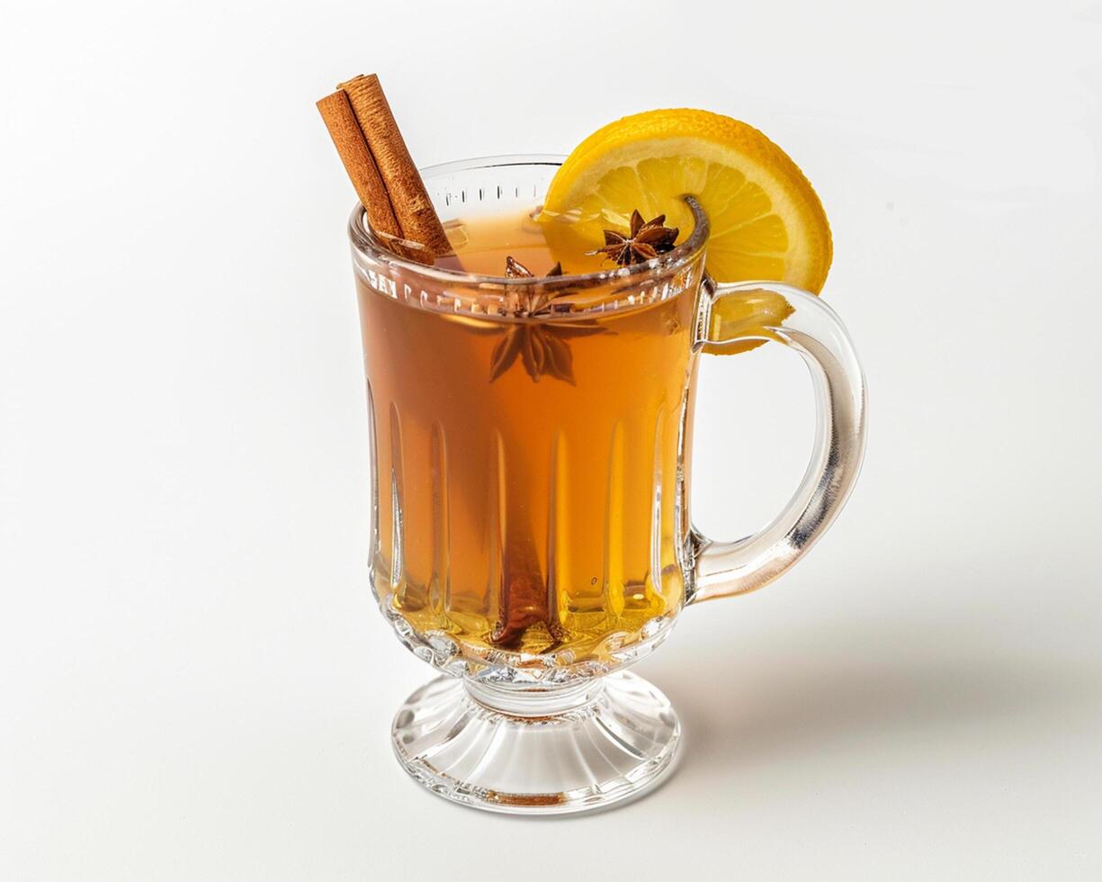 a glass of hot tea with cinnamon and lemon photo
