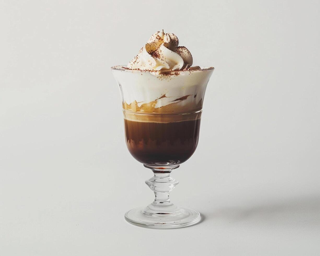 a glass of coffee with whipped cream and a sprinkle of cinnamon photo