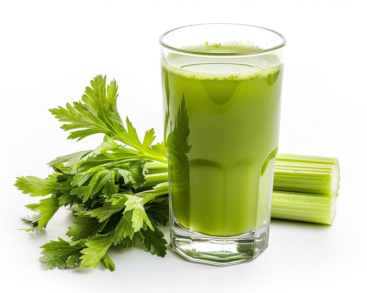 a glass of green juice with celery and celery photo