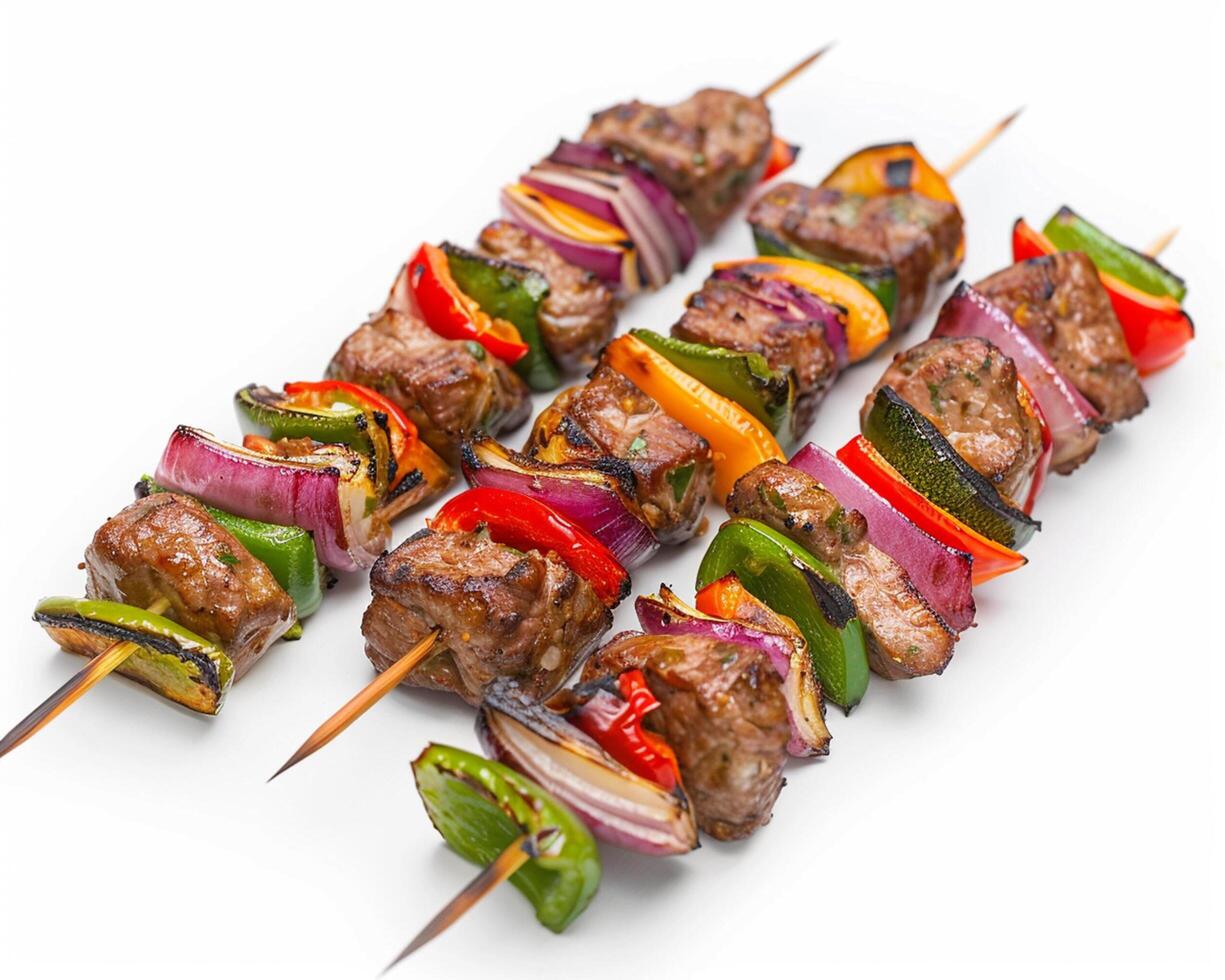 a group of meat skewers with vegetables on them photo