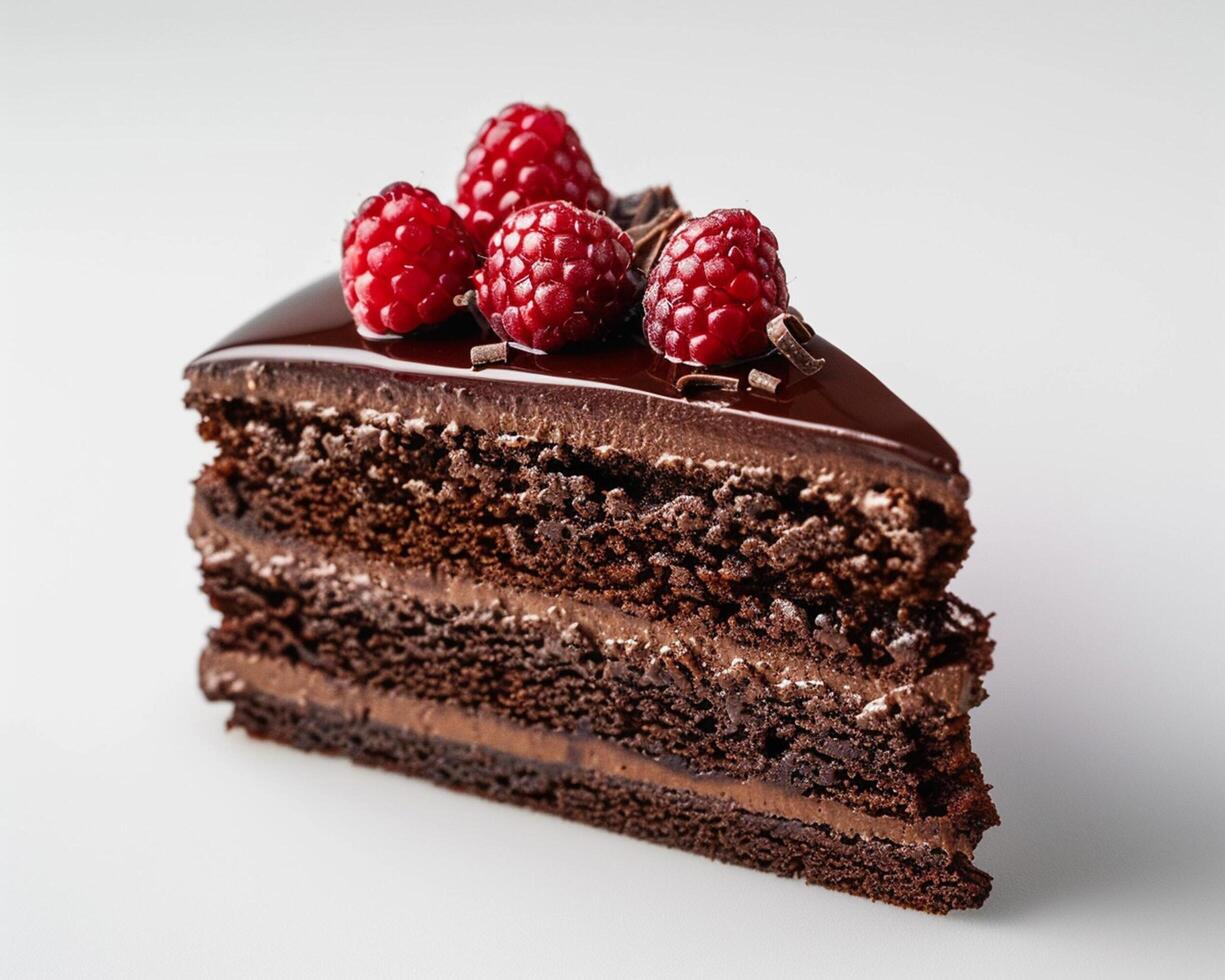 a piece of chocolate cake with raspberries on top photo