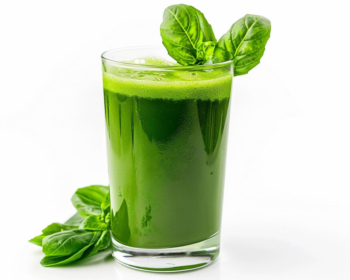 a glass of green juice with a leaf on top photo