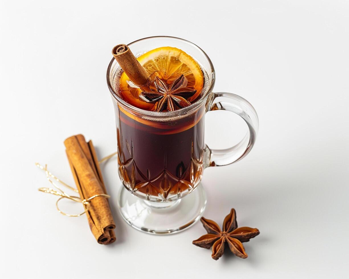a glass of hot mulled wine with cinnamon and star anise photo