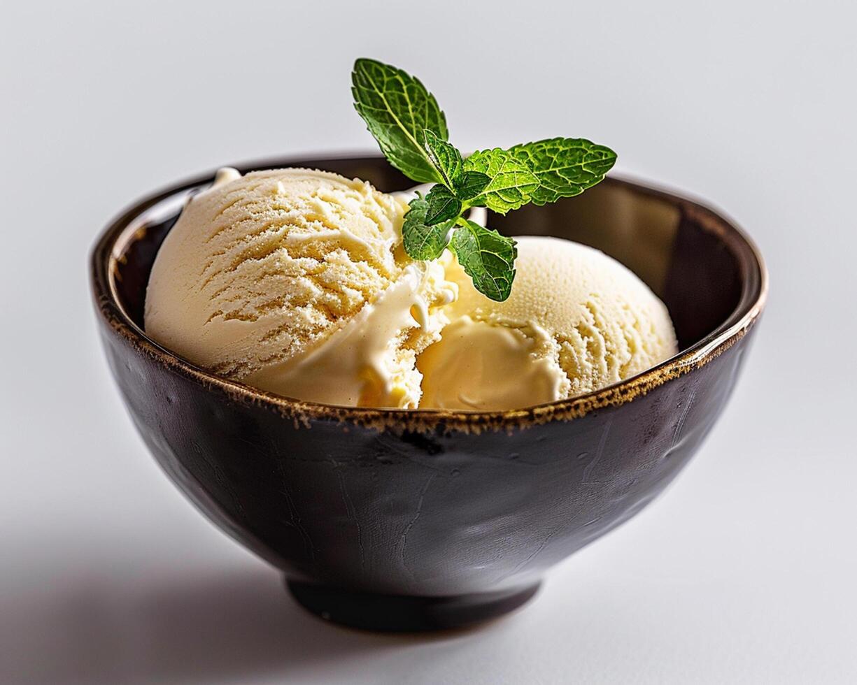 a bowl of ice cream with a mint leaf on top photo
