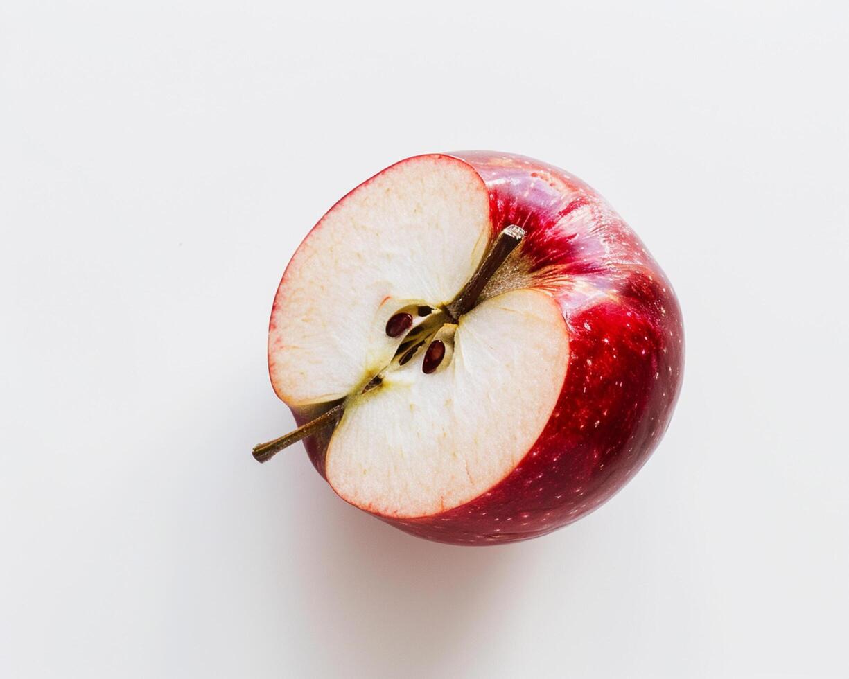 an apple is cut in half on a white surface photo