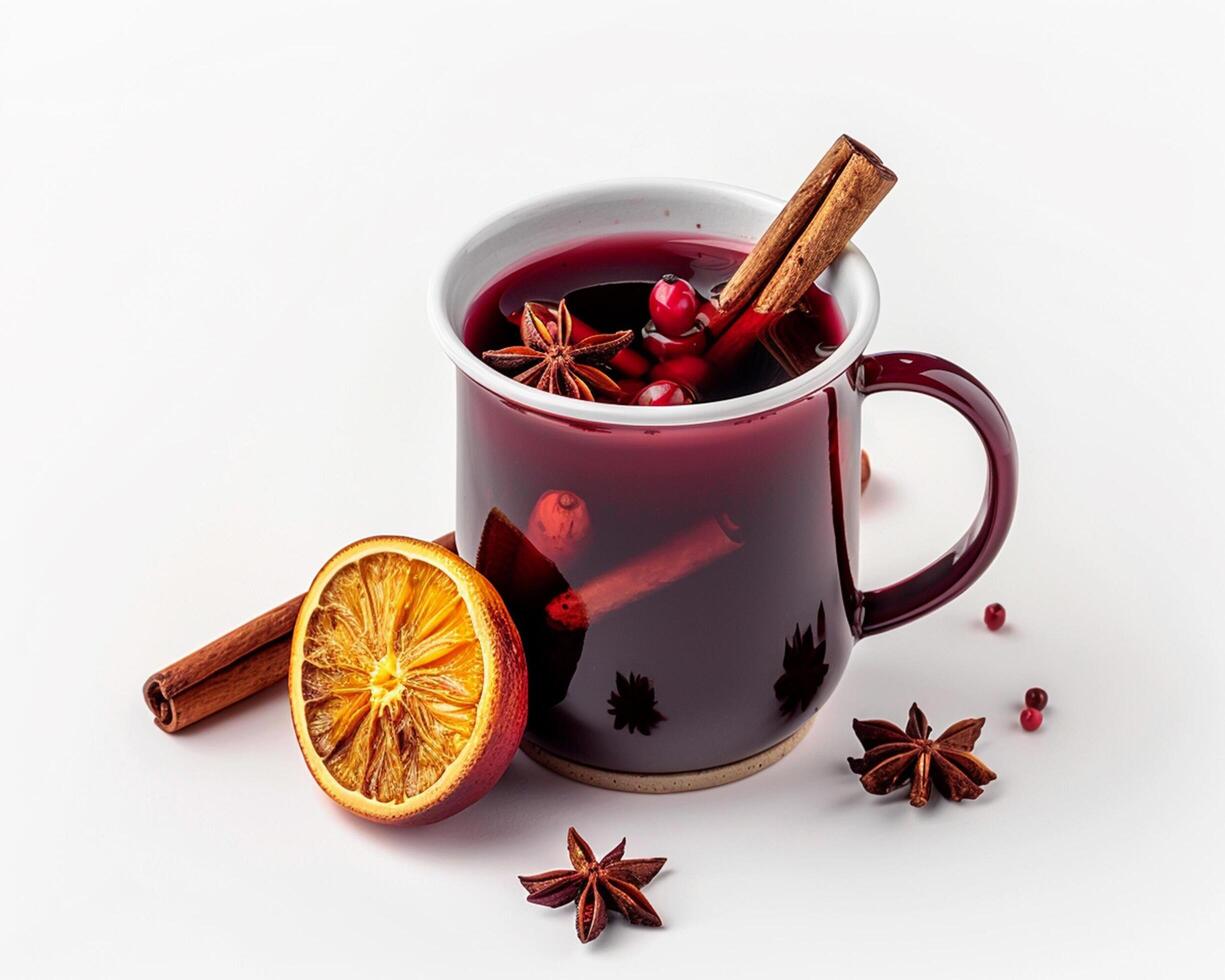 a mug of mulled wine with cinnamon, an orange and star anise photo