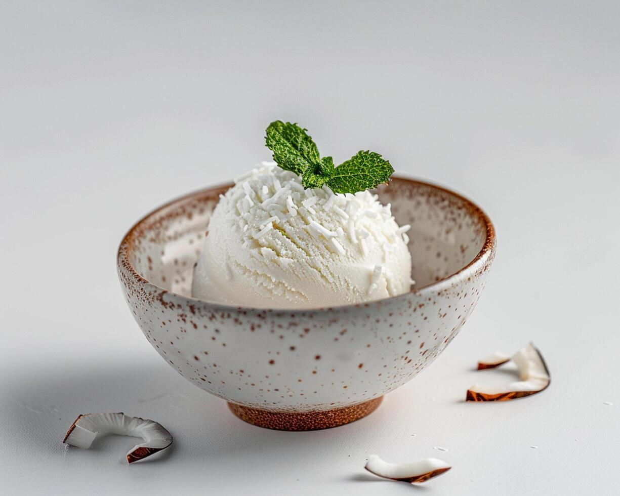 a bowl of ice cream with a mint leaf on top photo