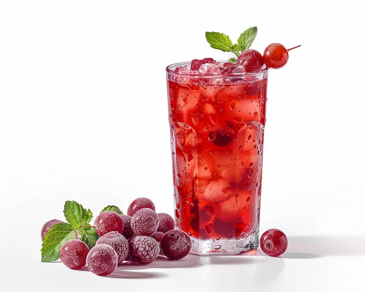 a glass of red drink with ice and cherries photo