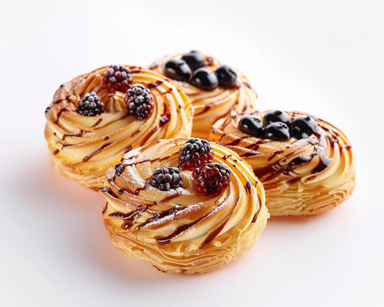 three pastry pastries with berries and chocolate photo