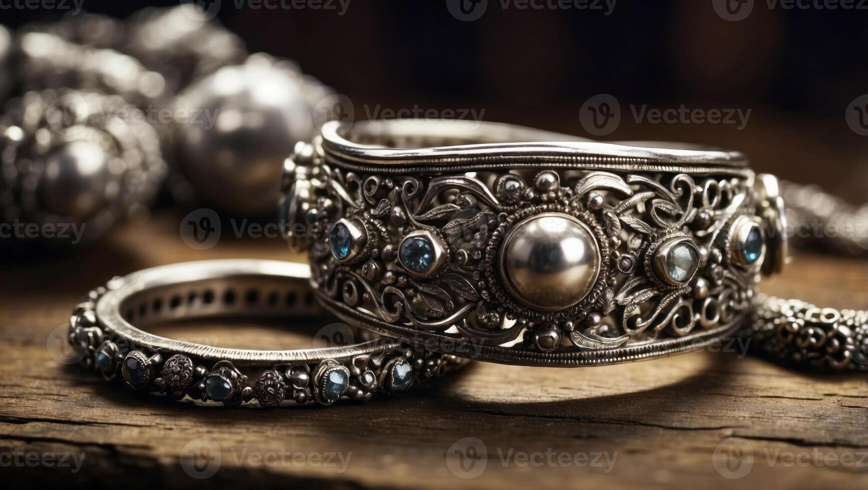 Collection of antique traditional silver jewelry on old wood. photo