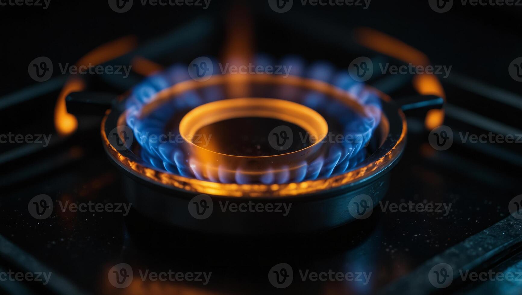 Gas burner flame on black, kitchen gas cooker with orange blue burning fire propane gas on dark background with copy space. photo