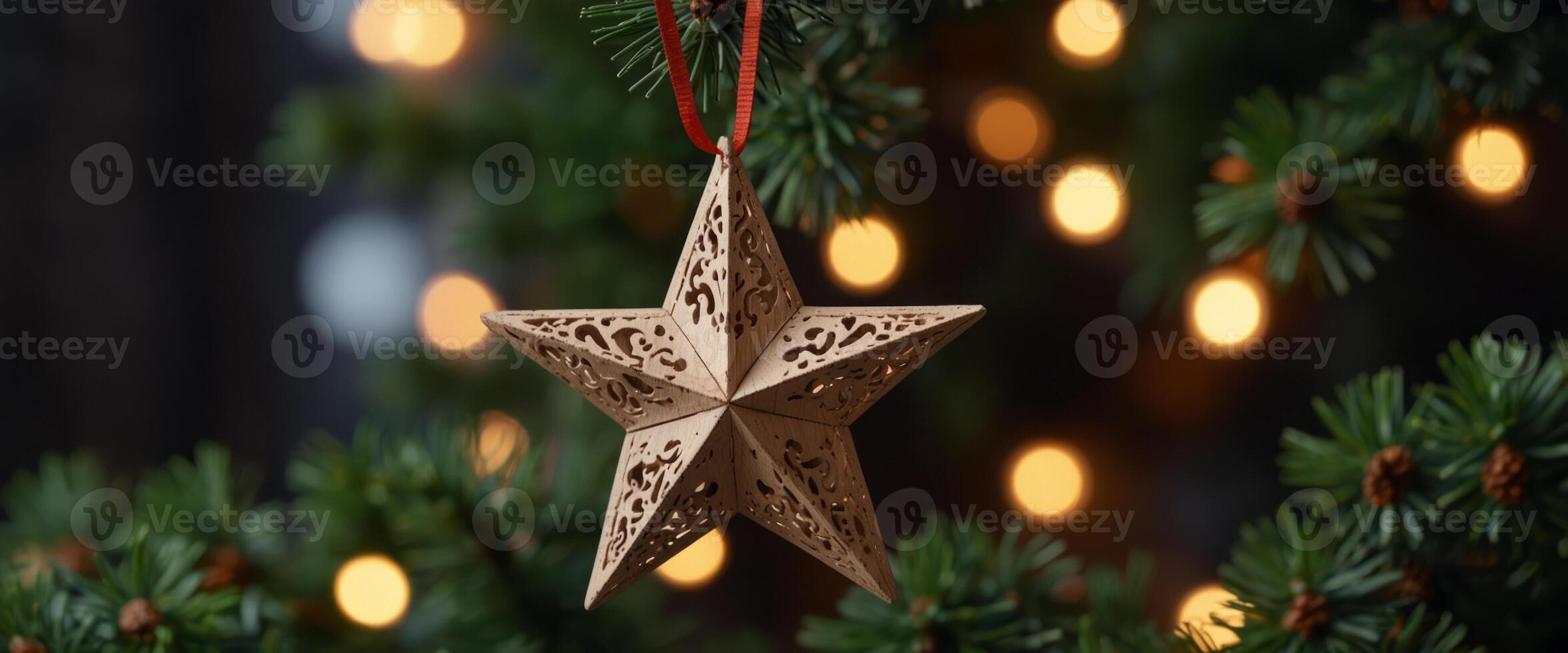 Wooden Christmas hanger in form of a star hanging on a fir tree. photo