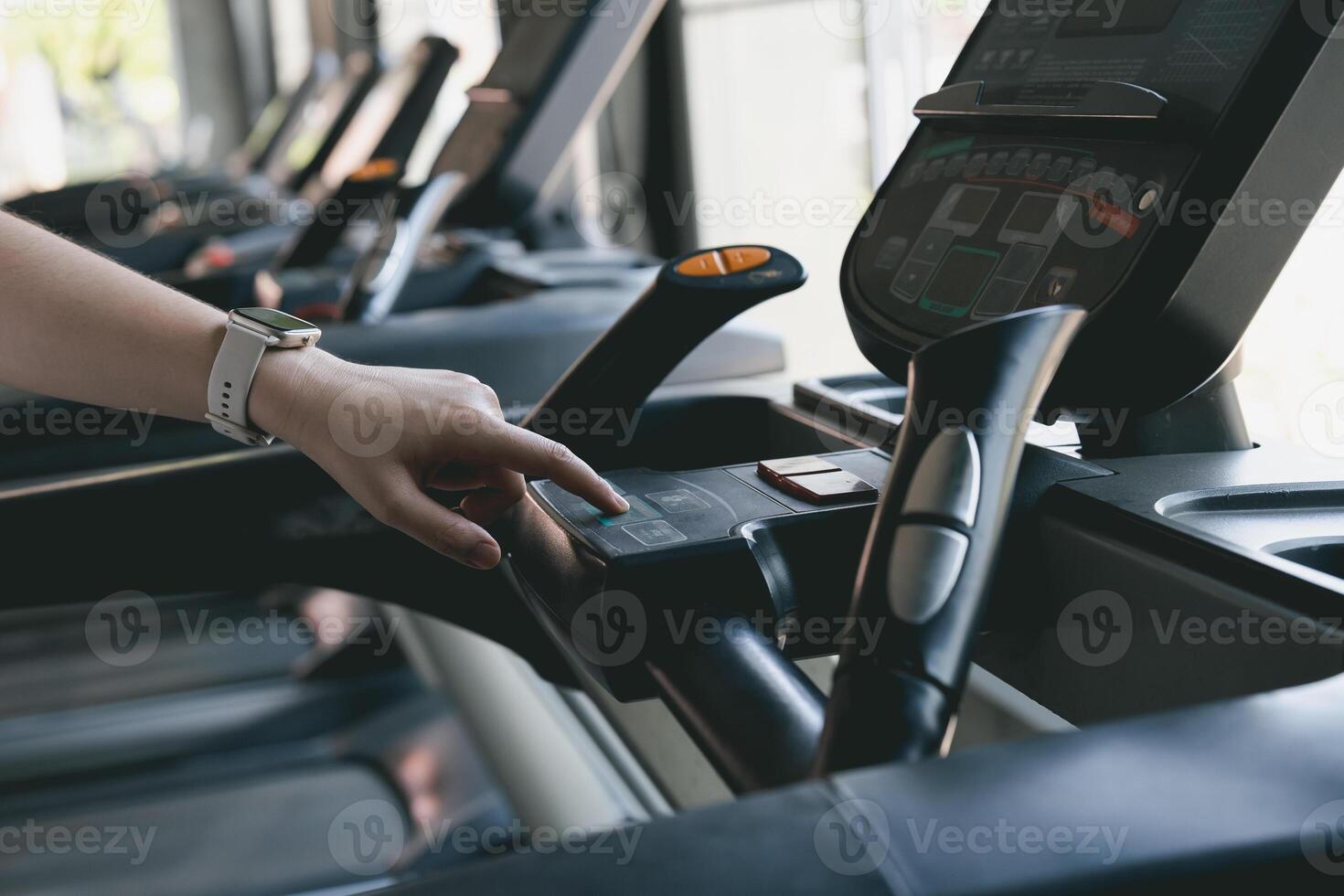 A woman is touching a machine with a button on it photo