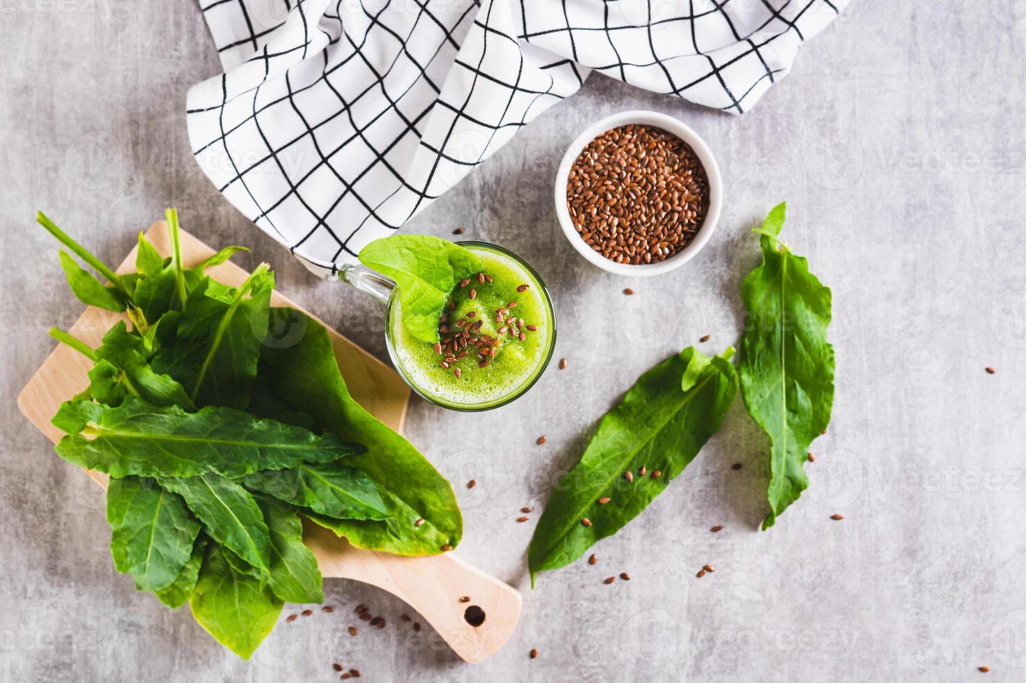 Refreshing smoothie made from sorrel leaves and flax seeds in a glass on the table top view photo