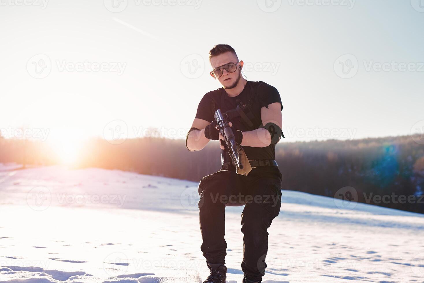 soldier with weapons in forest somewhere above the Arctic Circle photo