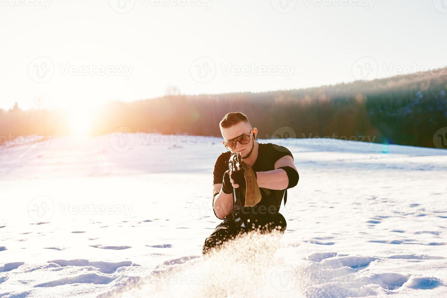 soldier with weapons in forest somewhere above the Arctic Circle photo