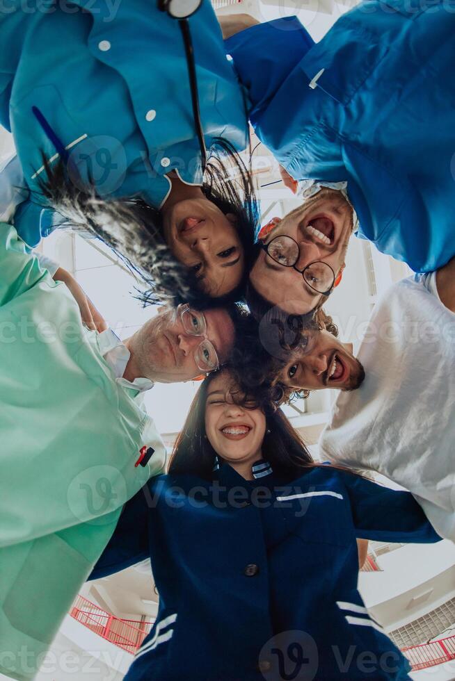 Group of doctors a medical nurse, and a surgeon are captured in a heartfelt embrace, showcasing their unity, teamwork, and profound connection in the healthcare field. photo