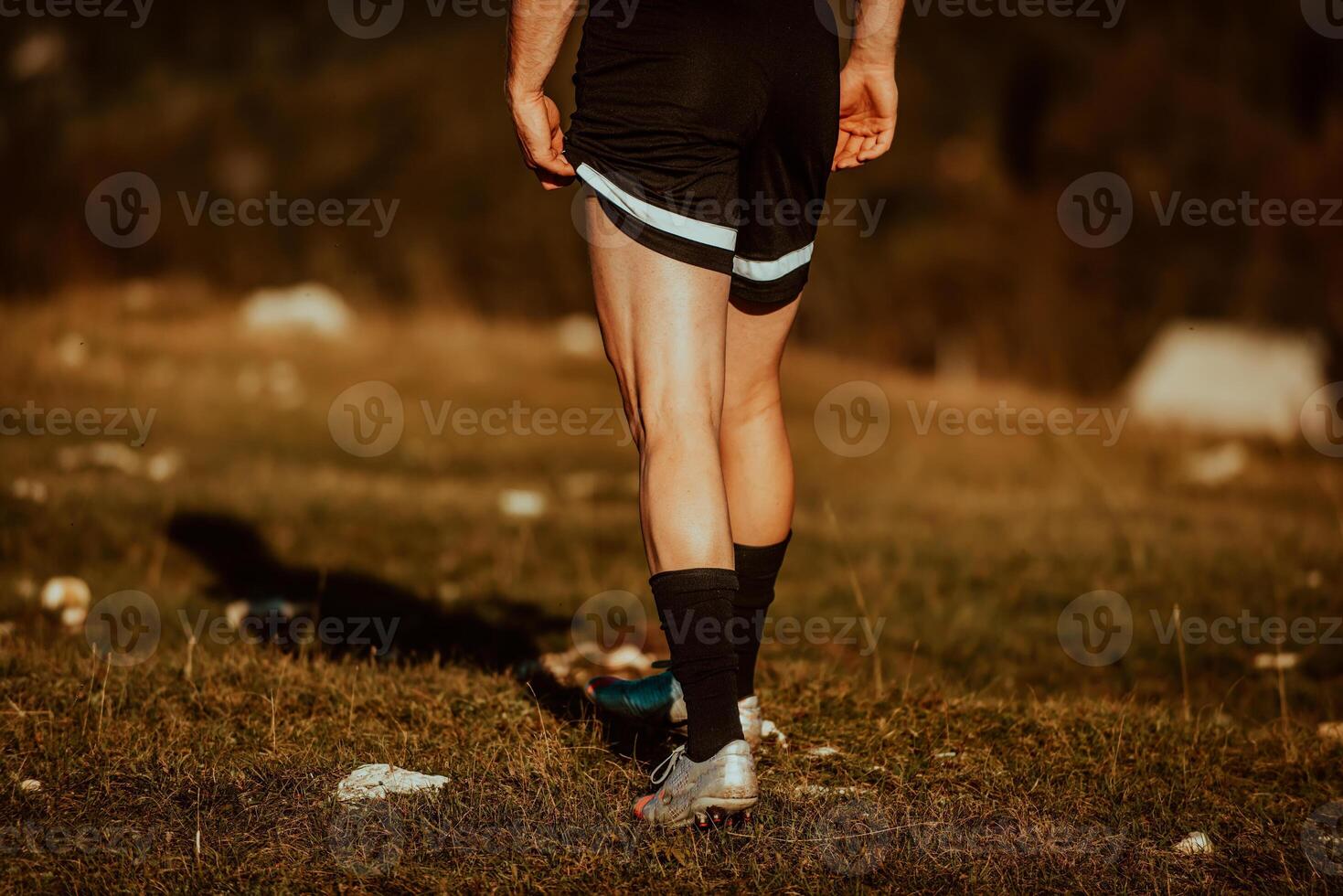 A man stretching after a hard workout in the early hours of the morning photo