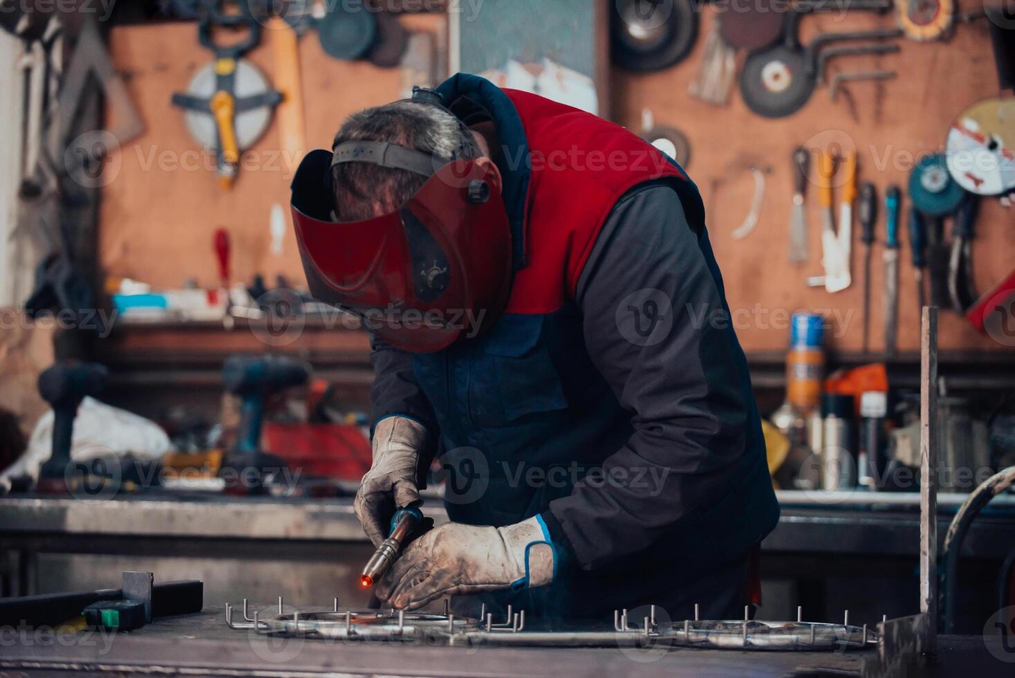 Welder erecting technical steel. Industrial steel welder in factory technical photo