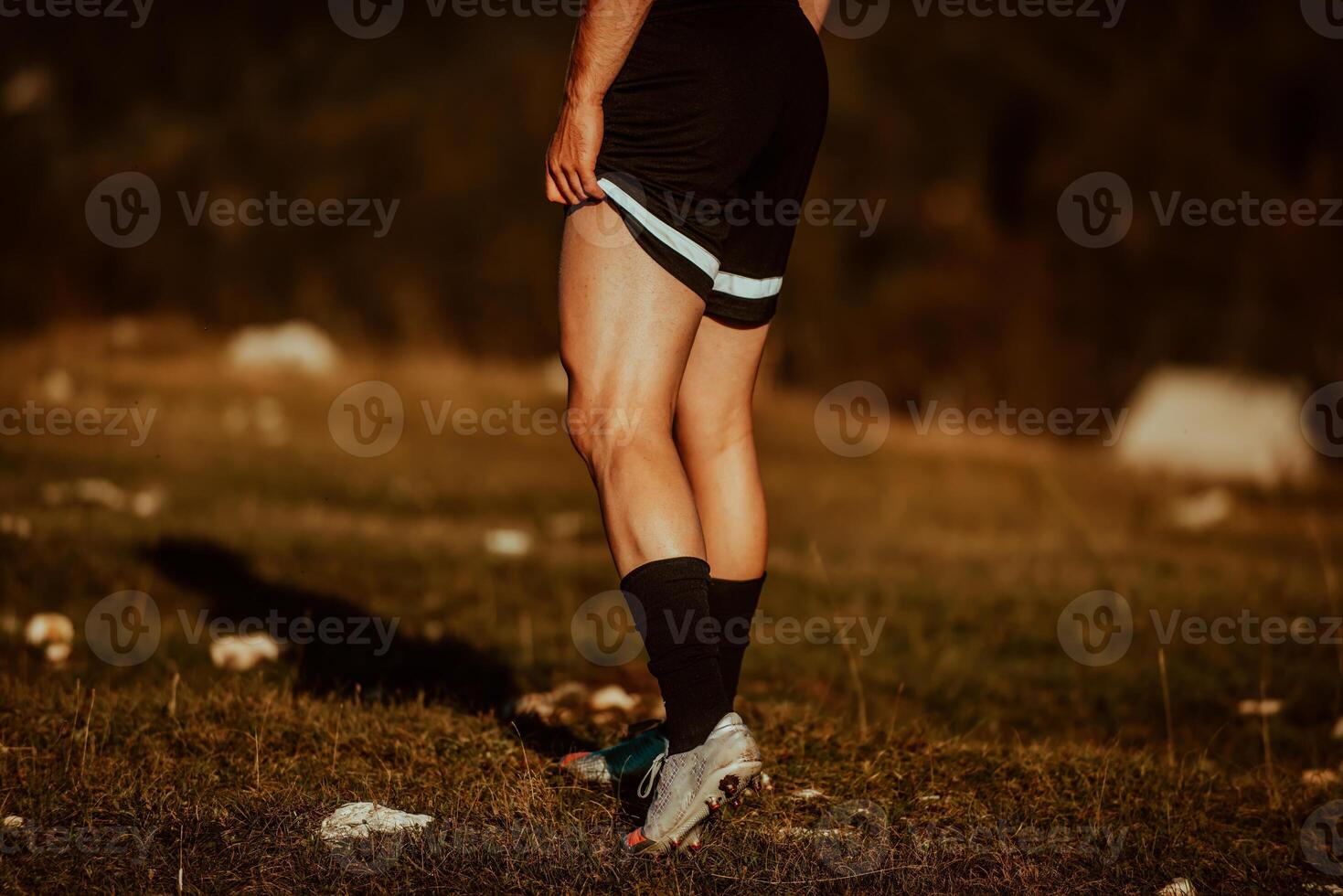 A man stretching after a hard workout in the early hours of the morning photo