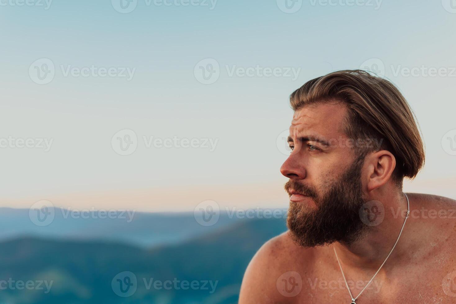 An athlete rests on top of a mountain after exhausting running training. photo