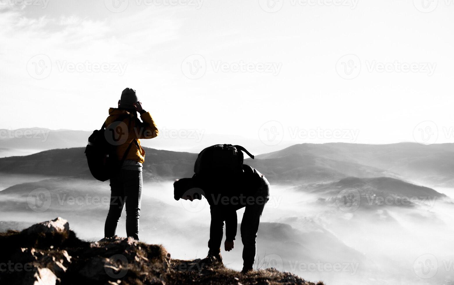 happy couple man and woman tourist at top of mountain during a hike in summer photo