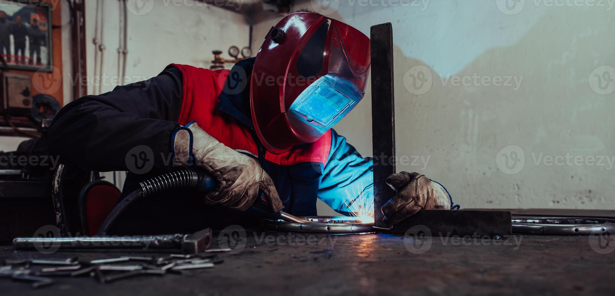 Welder erecting technical steel. Industrial steel welder in factory technical photo